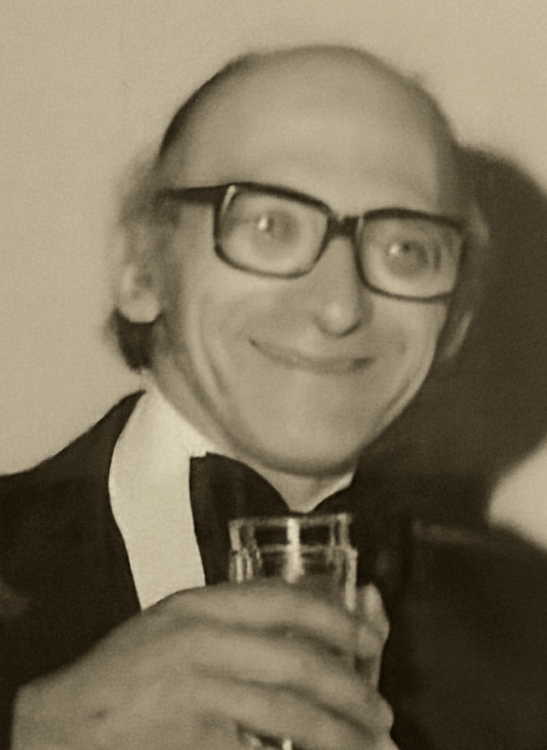 Alphonse M. DeGidio, smiling and raising a glass in a toast